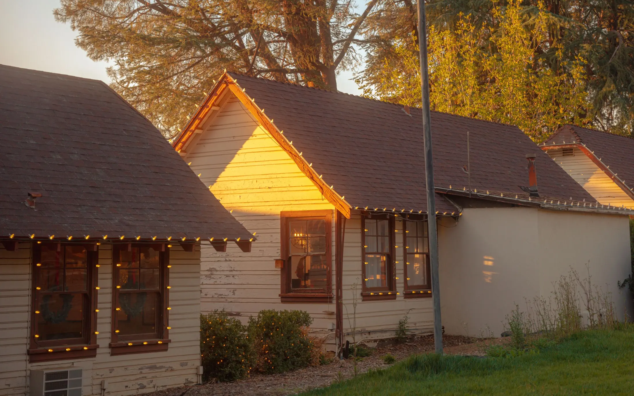 Homes with shingle roofs glowing at golden hour